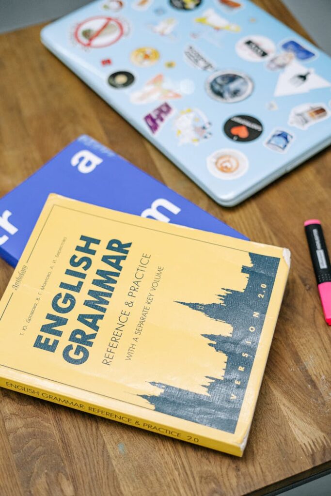 pexels-photo-5676740 Laptop and Books on Brown Wooden Table